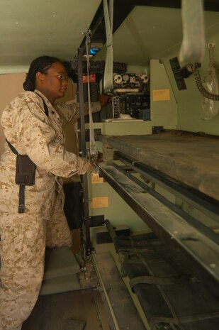 Al Asad, Iraq--Petty Officer 2nd Class Tony Wallace, 32, a native of Aiken, S.C. inspects the inside of the field ambulance operated by her unit.  Wallace is assigned to Marine Wing Support Squadron 271s combat medical unit.