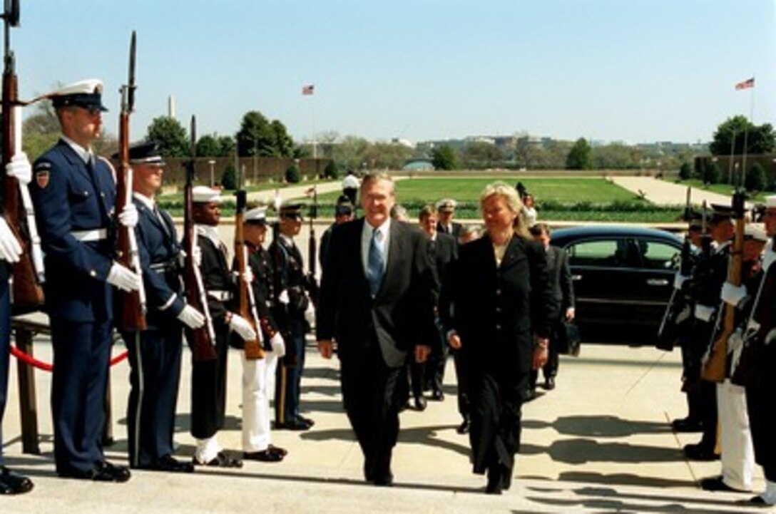 Secretary of Defense Donald H. Rumsfeld (left) escorts Norwegian Minister of Defense Kristin Krohn Devold (right) through an honor cordon and into the Pentagon on April 2, 2002. Rumsfeld and Devold will meet to discuss defense issues of mutual interest. 