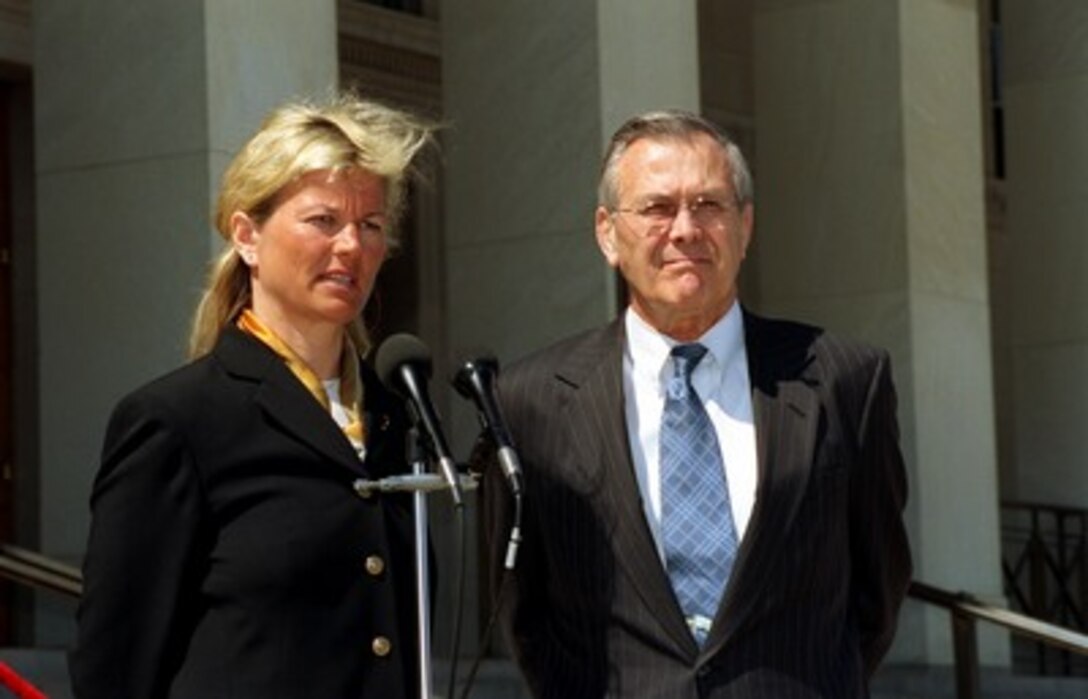 Norwegian Minister of Defense Kristin Krohn Devold (left) responds to a reporter's question during a joint media availability with Secretary of Defense Donald H. Rumsfeld outside the Pentagon on April 2, 2002. Devold and Rumsfeld met earlier to discuss defense issues of mutual interest. 