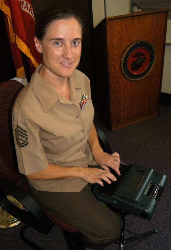 Court reporter GySgt. Patricia R. Smith with 1st Service Support Group sits behind her stenograph short hand machine in a Leagal Services and Support Section conference room Sept 22. Smith is one of  few Marines to type 225 words per minute on the machine.