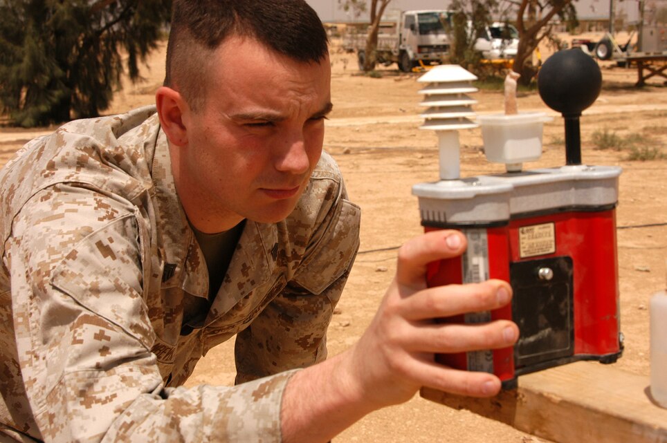 AL ASAD, Iraq (May 3, 2005) - Sgt. David L. Van Bever, weather observer and native of Paramus, N.J., checks the temperature data on a wet-bulb thermometer. The special thermometer factors in actual temperature, a wet temperature and a special copper ball then uses an equation to determine the temperature as it relates to the human body. The wet temperature mimics the effect of perspiration.