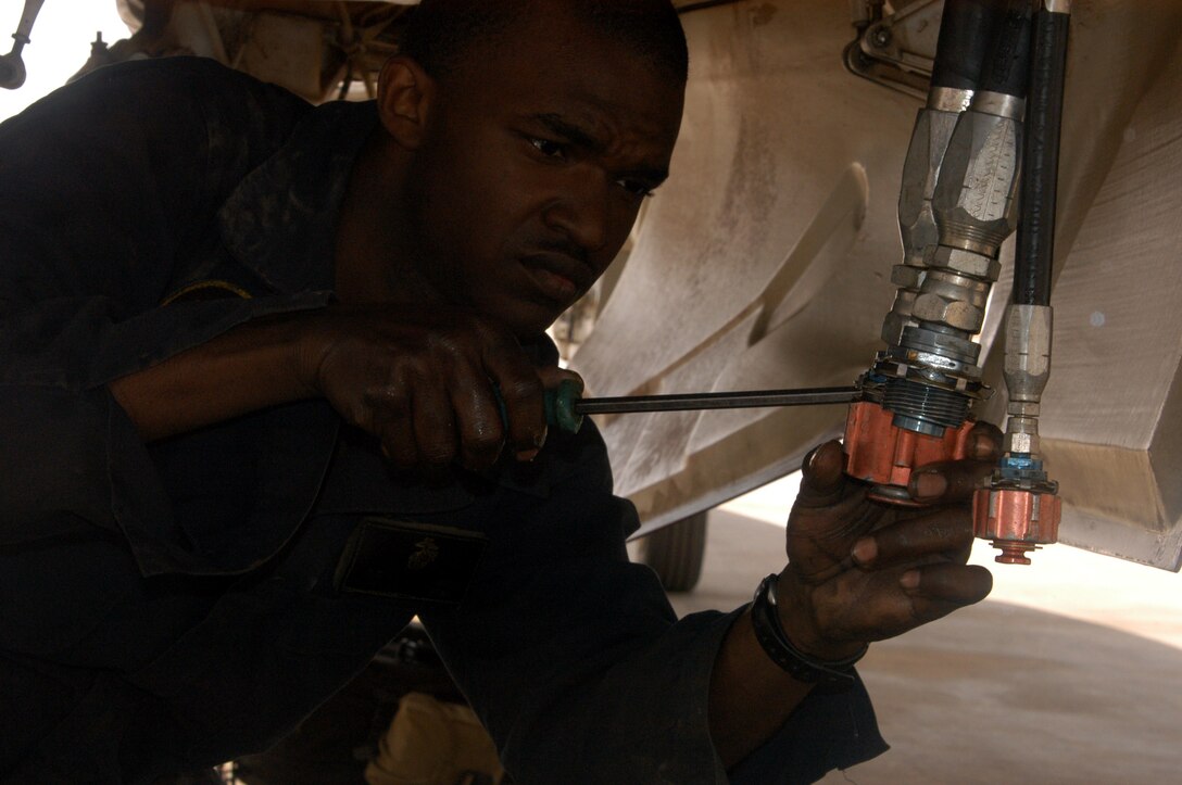 AL ASAD, Iraq (May 9, 2005) - Cpl. Brandon C. Hall, airframes mechanic and native of Houston, prepares to replace and service the hydraulic fluid on one of Marine All Weather Fighter Attack Squadron 224's F/A-18D Hornets. Hall and the Marines of VMFA(AW)-224 have recently surpassed 3,000 combat flight hours since their arrival here in January.
