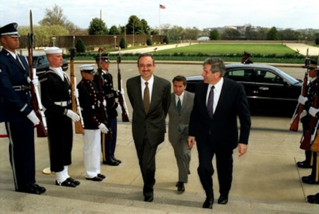 Jordanian Foreign Minister Marwan Muasher (left) is escorted by Deputy Secretary of Defense Paul Wolfowitz (right) as he arrives at the Pentagon on April 5, 2002. Muasher and Wolfowitz will meet to discuss a range of regional security issues. 