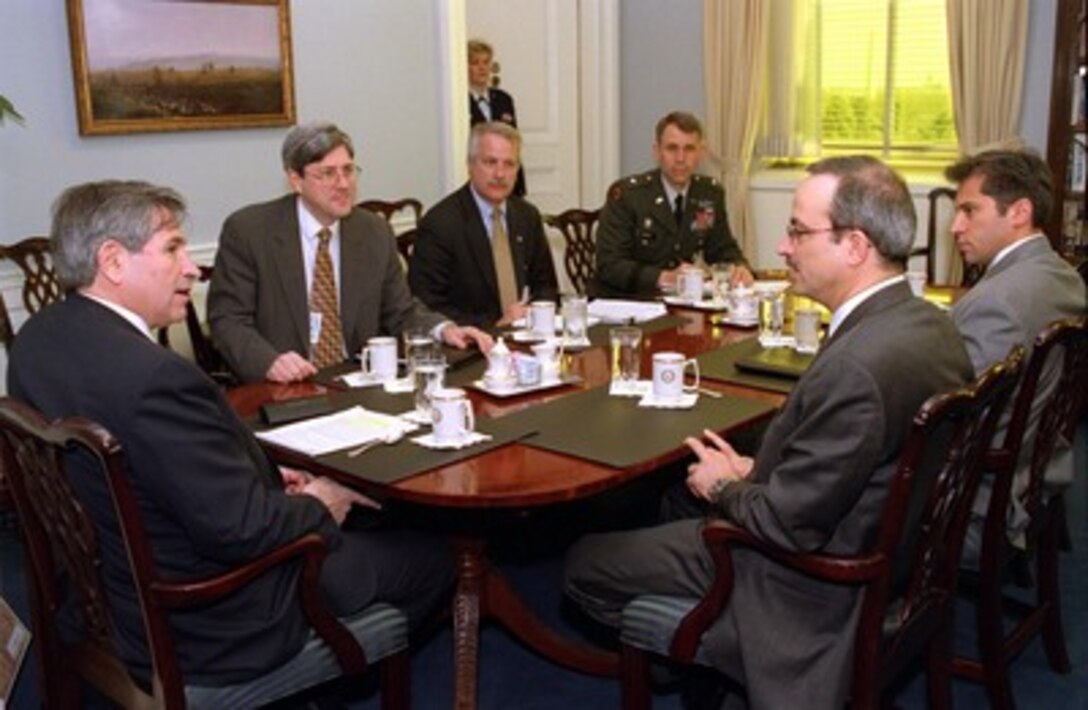 Deputy Secretary of Defense Paul Wolfowitz (left) meets with Jordanian Foreign Minister Marwan Muasher (right foreground) in the Pentagon on April 5, 2002, to discuss a range of regional security issues. Under Secretary of Defense for Policy Douglas Feith (2nd from left), Deputy Assistant Secretary of Defense for Near Eastern and South Asian Affairs William Luti, Military Assistant to the Deputy Secretary of Defense Gen. John Batiste, and Mr. Hassan, the deputy chief of mission at the Jordanian Embassy in Washington, D. C., joined Wolfowitz and Muasher for the talks. 