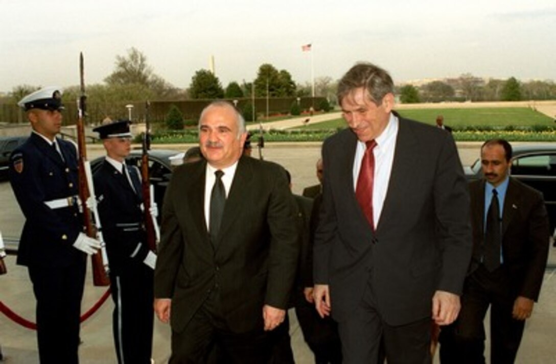 Prince El Hassan bin Talal (left, of Jordan, is escorted into the Pentagon by Deputy Secretary of Defense Paul Wolfowitz for discussions on regional security issues on April 8, 2002. 