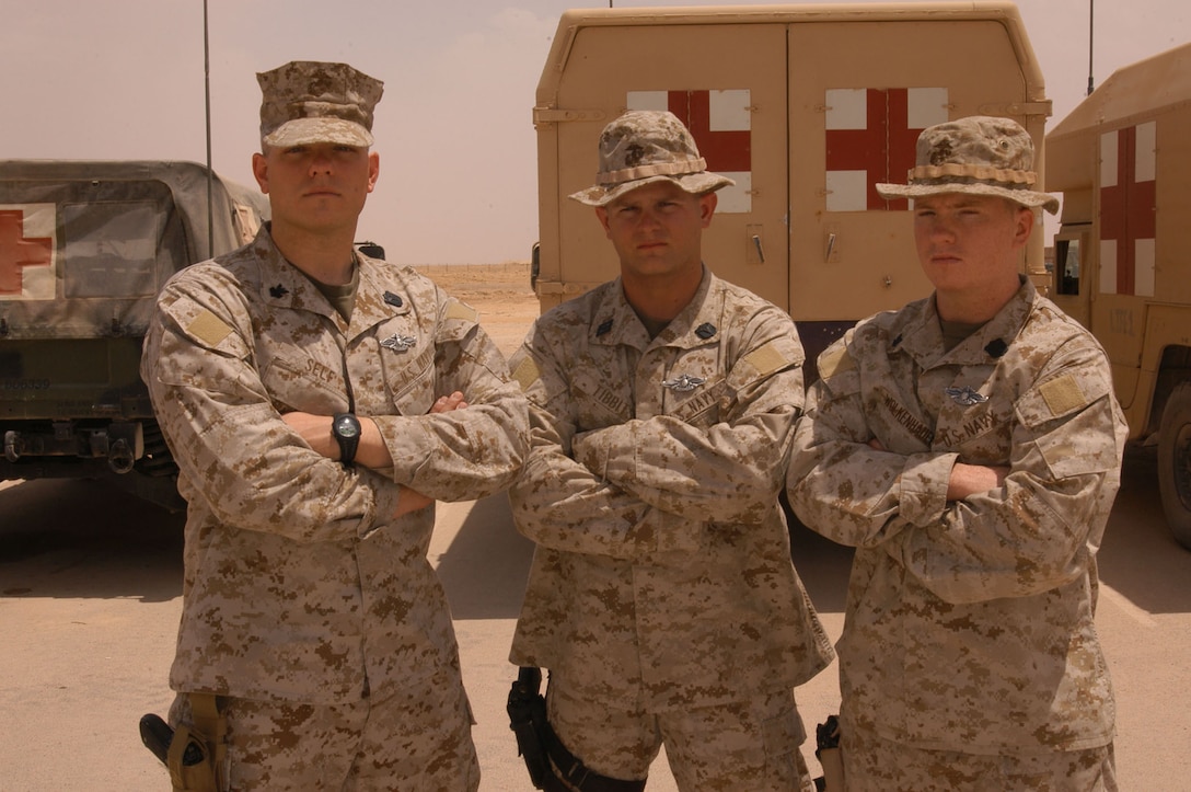 Enlisted Fleet Marine Force Warfare Specialists HM1(FMF) Dennis Self, HN(FMF) Joseph Tibbits, and HM3(FMF) Dale Wolkenhauer proudly display the new Fleet Marine Force pin they were awarded May 15. The sailors endured more than 100 hours of intense written and practical application to qualify for the pin that was adopted into the U.S. Navy enlisted ranks in July 2000.  The sailors were required to master 14 core subjects ranging from Marine Corps history and weapons systems to a Marine Air Ground Task Force.