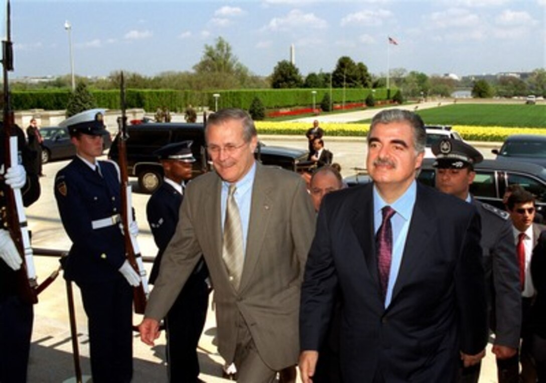 Secretary of Defense Donald H. Rumsfeld (left) escorts Lebanese Prime Minister Rafiq Hariri through an honor cordon and into the Pentagon for a meeting on April 16, 2002. Rumsfeld and Hariri will meet to discuss a range of bilateral security issues. 