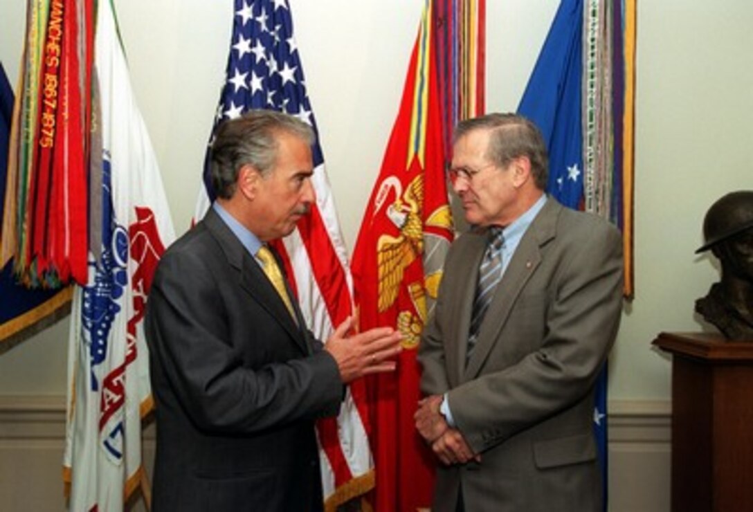 Colombian President Andres Pastrana (left) speaks privately with Secretary of Defense Donald H. Rumsfeld in the Pentagon on April 17, 2002. Pastrana is meeting briefly with Rumsfeld and formally with Deputy Secretary of Defense Paul Wolfowitz to discuss a range of security issues. 