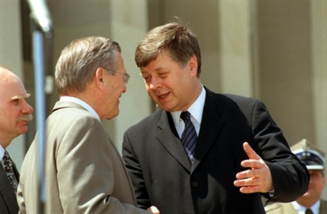 Secretary of Defense Donald H. Rumsfeld (center) bids farewell to Polish Defense Minister Jerzy Szmajdzinski (right) at the Pentagon on April 23, 2002. Rumsfeld and Szmajdzinski met earlier to discuss a broad range of bilateral and NATO-related security issues. 