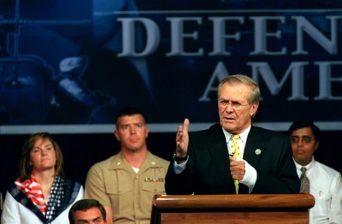 Secretary of Defense Donald H. Rumsfeld gestures as he emphasizes a point during a town hall meeting in the Pentagon on Aug. 6, 2002. Rumsfeld told the audience of the need for transformation in the Department of Defense. The meeting provides an opportunity for the Pentagon's military and civilian employees to ask questions of the secretary. This was Rumsfeld's third such meeting with his employees since taking office in January 2001. 