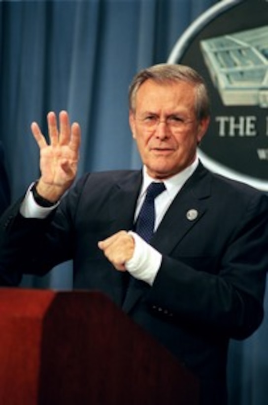 Secretary of Defense Donald H. Rumsfeld answers a reporter's question during a Pentagon press conference on Aug. 7, 2002. Rumsfeld briefed reporters on some developments in the war on terrorism in Afghanistan. Rumsfeld's left forearm is in a cast following recent surgery to repair an arthritic thumb. 