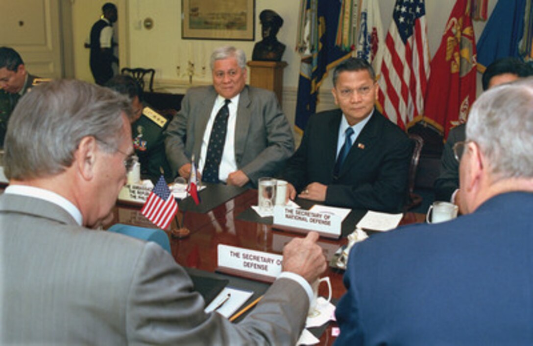 Philippine Minister of National Defense Angelo Reyes (right, far-side) meets with Secretary of Defense Donald H. Rumsfeld (left foreground) and Chairman of the Joint Chiefs of Staff Gen. Richard B. Myers (right foreground), U.S. Air Force, in the Pentagon on Aug. 12, 2002. Ambassador to the United States Albert Del Rosario joined Reyes in the talks. 