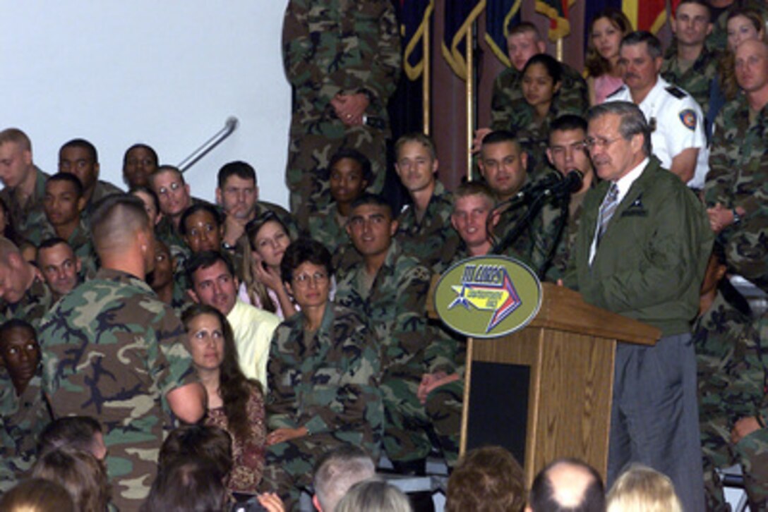 Secretary of Defense Donald Rumsfeld answers a soldier's question during a town hall meeting at Fort Hood on Aug. 21, 2002. 
