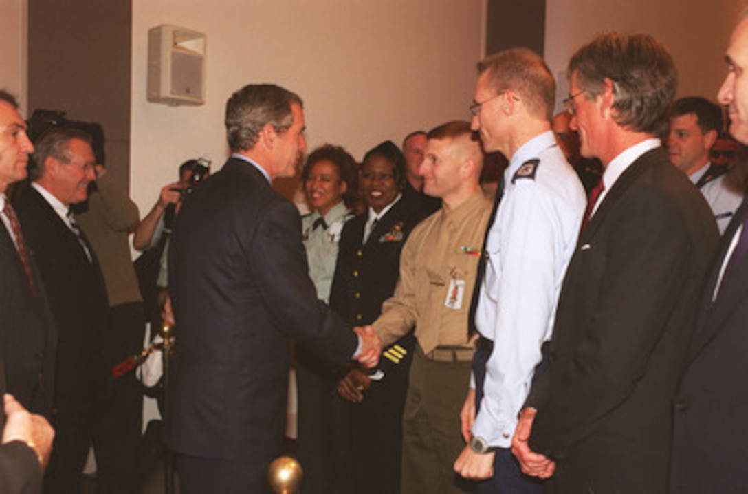 President George W. Bush shakes hands with Marine Sgt. Robert J. Wenier as he leaves the Pentagon auditorium on Dec. 2, 2002. Bush was at the Pentagon to sign the Department of Defense Authorization Bill and to speak to military and DoD civilian personnel. 