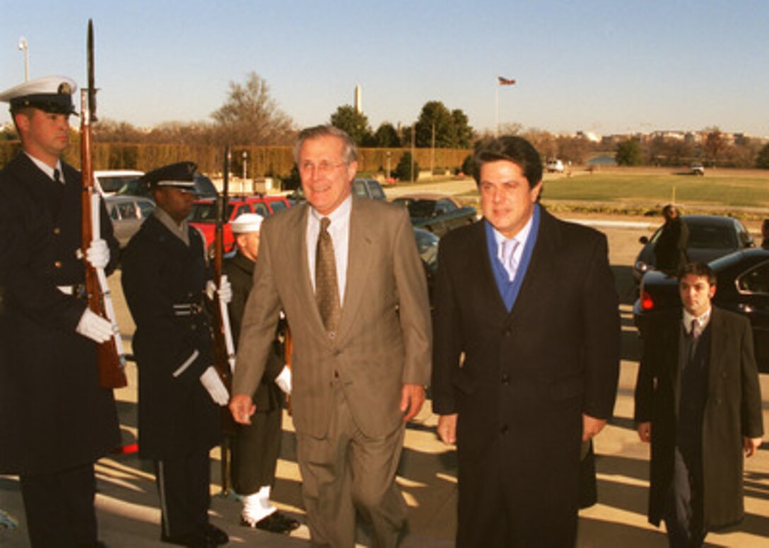 Secretary of Defense Donald H. Rumsfeld (left) escorts Spanish Minister of Defense Federico Trillo (right) into the Pentagon on Dec. 3, 2002. The two defense leaders will meet to discuss bilateral security issues and sign documents formalizing military cooperation programs between the two nations. 