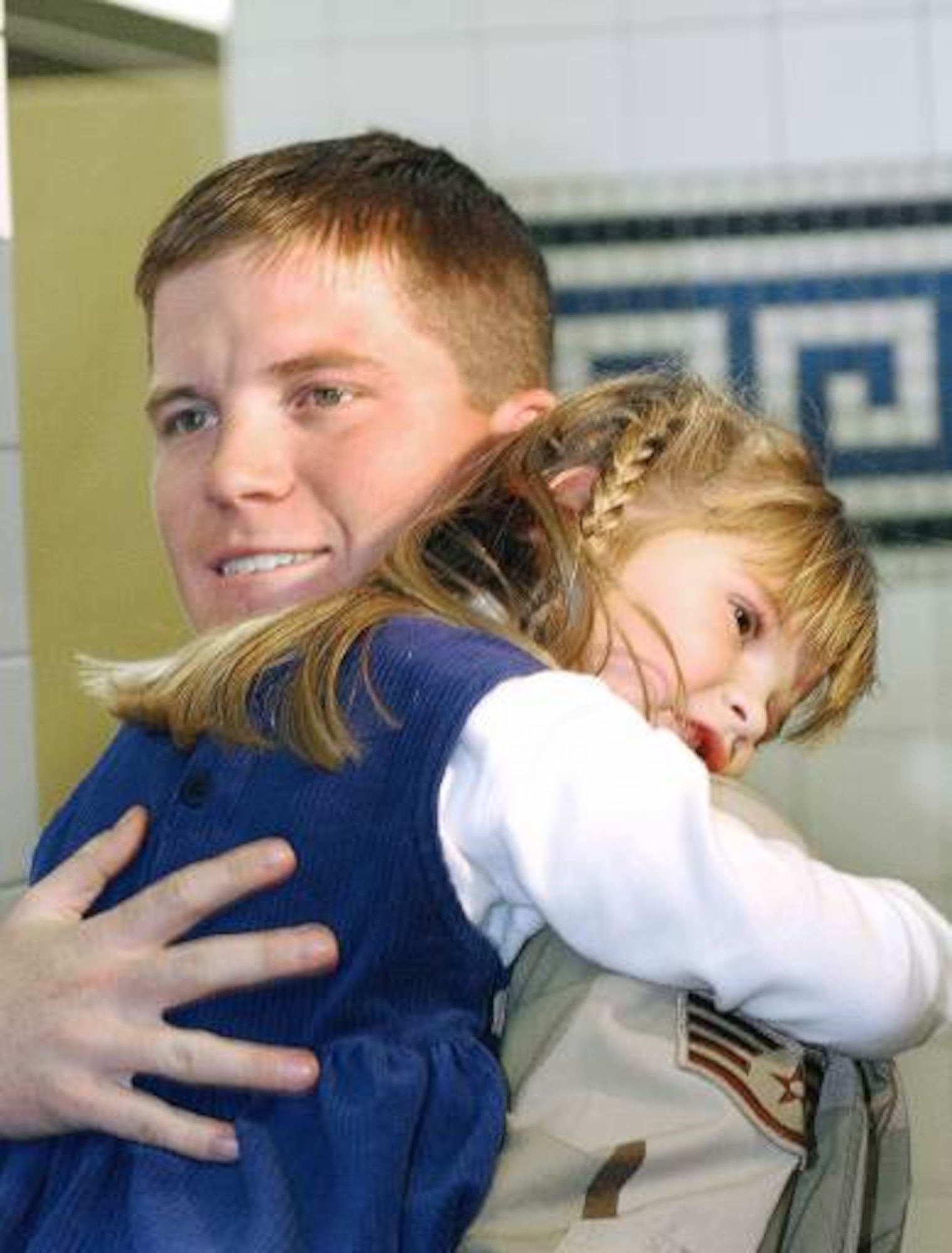 DOVER AIR FORCE BASE, Del. -- Staff Sgt. Joe Neubaur holds his 4-year-old daughter, Katlyn, in the passenger terminal here after returning from a three-month deployment to Kandahar, Afghanistan, as part of Operation Enduring Freedom. Neubaur is assigned to Dover's 436th Aerial Port Squadron. (U.S. Air Force photo by Alex Dorgan-Ross)