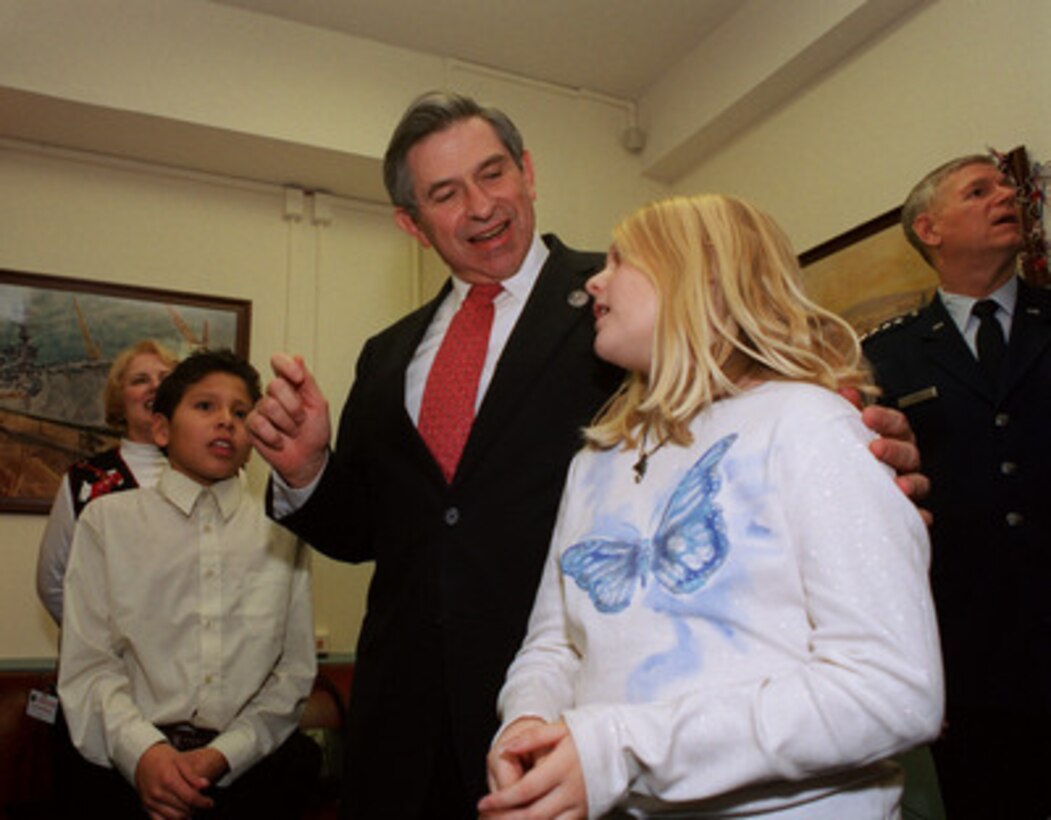 Deputy Secretary of Defense Paul Wolfowitz leads Wyatt Red Cloud and Karissa Pierce, two grade-school children from Idaho, in a countdown to the lighting of the Pentagon holiday tree on Dec. 13, 2002. Gen. Richard B. Myers (right), U.S. Air Force, chairman of the Joint Chiefs of Staff, looks out to see the first glow as the tree is lit. 