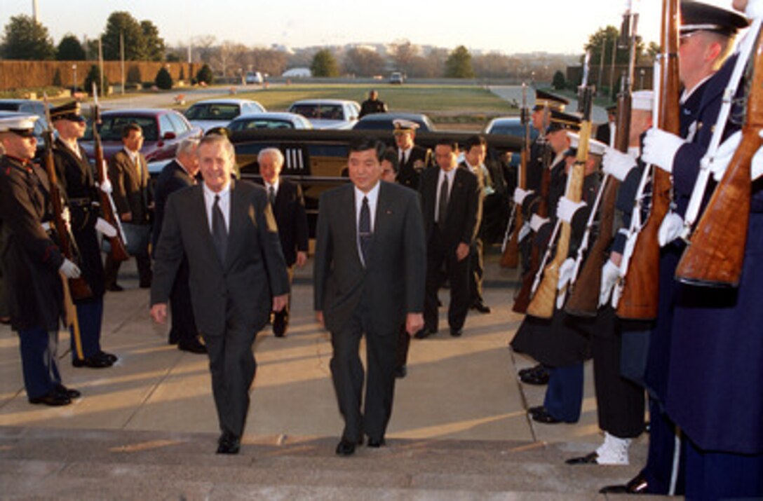 Secretary of Defense Donald H. Rumsfeld (left) escorts Japanese Minister of State for Defense Shigeru Ishiba into the Pentagon on the morning of Dec. 17, 2002. Rumsfeld and Ishiba will share a working breakfast together during which bilateral security issues will be discussed. 