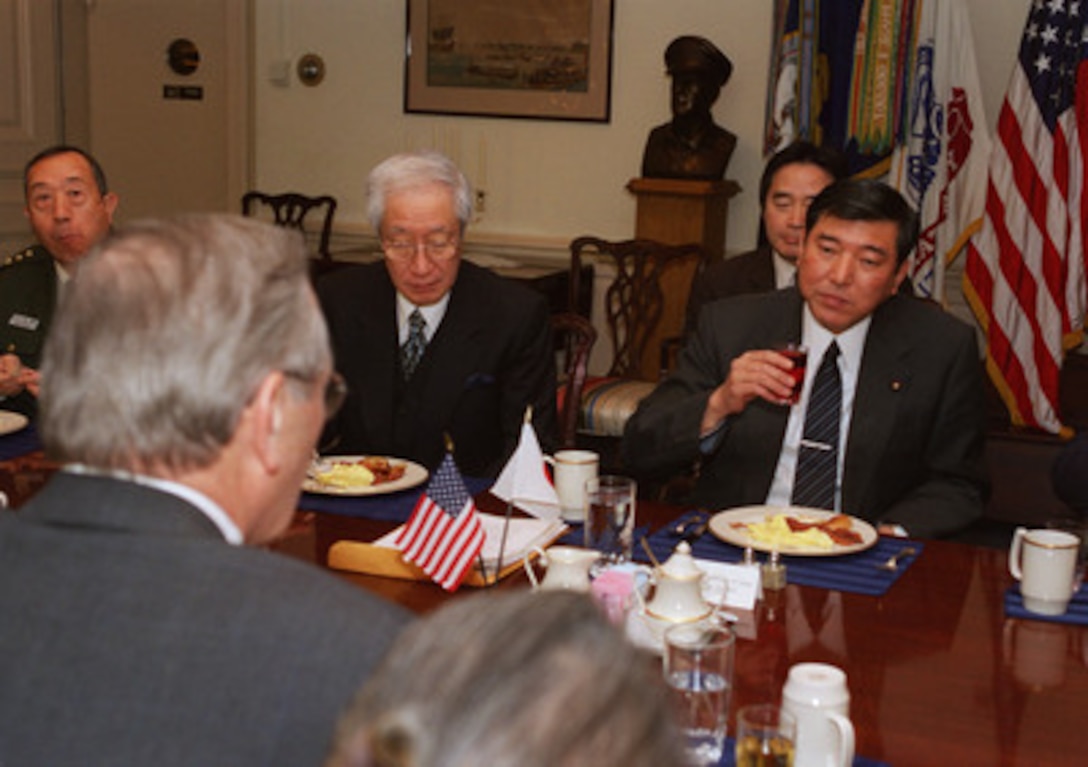 Japanese Minister of State for Defense Shigeru Ishiba (right) meets with Secretary of Defense Donald H. Rumsfeld (left, foreground) at a Pentagon working breakfast on Dec. 17, 2002. The two defense leaders discussed a range of bilateral security issues. 