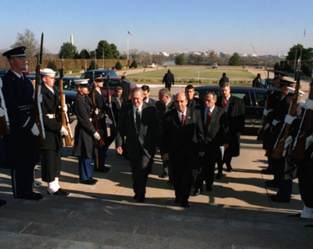 Secretary of Defense Donald H. Rumsfeld escorts Israeli Minister of Defense Shaul Mofaz into the Pentagon on Dec. 17, 2002. The two leaders are meeting to discuss defense issues of mutual interest. 
