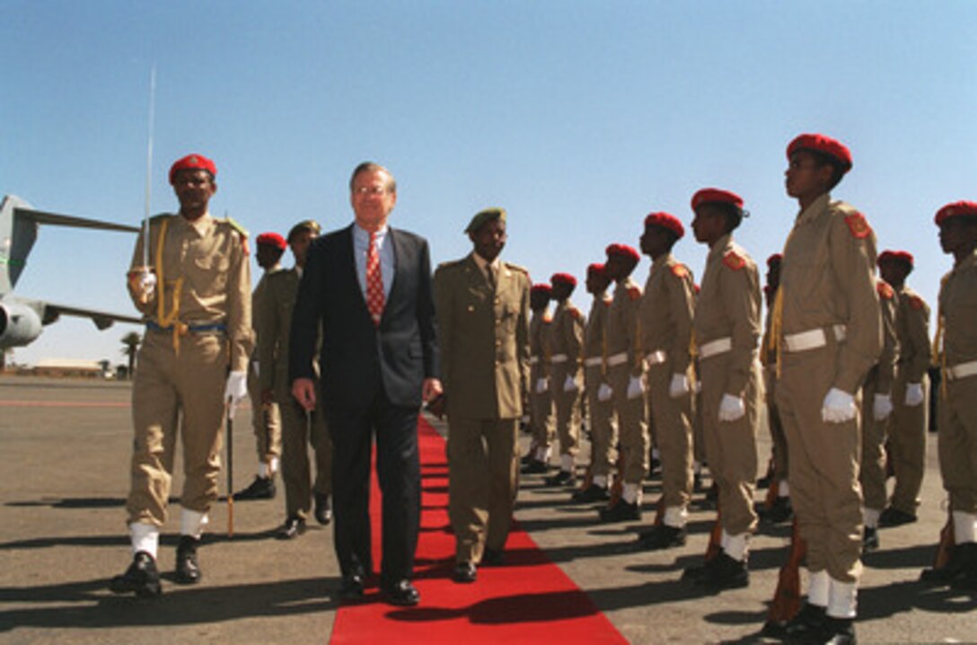 Secretary of Defense Donald H. Rumsfeld (center) and Minister of Defense Gen. Sebhat Ephraim (right) inspect troops during a welcoming ceremony on Dec. 10, 2002. Rumsfeld is in Asmara, Eritrea, to meet with leaders concerning defense issues of mutual interest. 