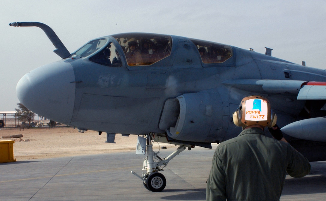 Sgt. Wayne A. Switzer, EA-6B plane captain renders a salute as one of Marine Tactical Electronic Warfare Squadron 4's Prowlers taxies out to take off.