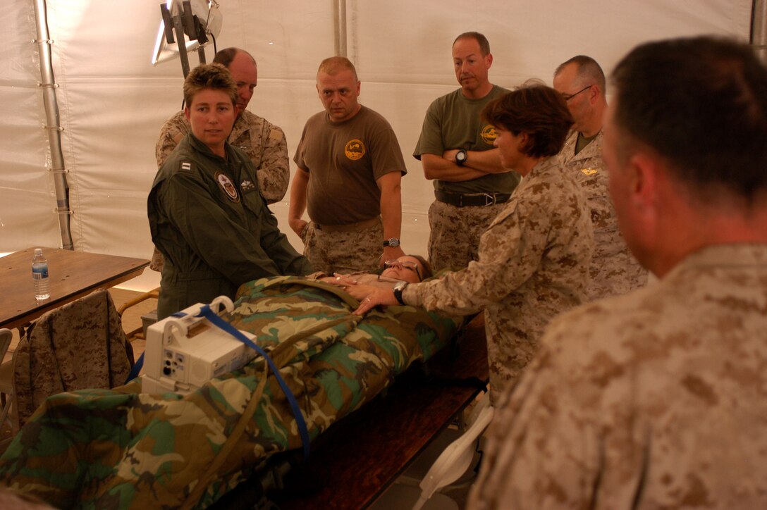 Lt. Noelle Griffith, of the U.S. Navy Reserve Nurse Corps, Fleet Surgery Team 9 from San Diego, instructs sailors from the 4th Medical Battalion in the operation of the Navy’s en route care system here June 11.   This device is utilized by the U.S. Armed Forces to expeditiously manage life support systems while injured troops are transported from the a remote field environment to a better-equipped medical facility. The en route care training class was offered as part of exercise Javelin Thrust 2009, a large-scale exercise with more than 2,600 Marines and sailors.  Javelin Thrust was designed to give reserve units practice in a wide range of combat and logistics capabilities to prepare Reserve units for their role in a deployed Marine Air Ground Task Force