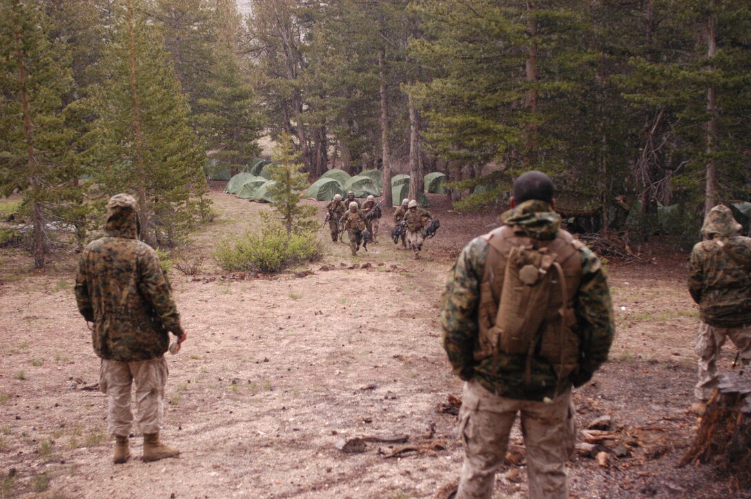 A machine gun squad with B Co., 1st Bn., 23rd Marine Regiment attacks the line during a gun drill at the Marine Corps Mountain Warfare Training Center here June 15. The drills were run as part of exercise Javelin Thrust 2009, which is training more than 2,000 Reserve Marines on the type of terrain and culture to be expected in future deployment to Afghanistan.