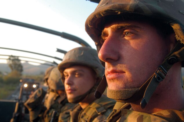 Lance Cpl. Trenton Lewis, an Marine air Group - 39 armorer, reflects on the mission ahead as the sun rises from behind Pendleton's mountains.
