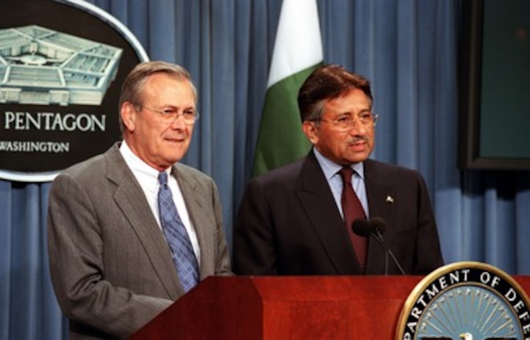 Pakistani President Pervez Musharraf (right) responds to a reporter's question during a joint press conference with Secretary of Defense Donald H. Rumsfeld (left) in the Pentagon on Feb. 13, 2002. Musharraf and Rumsfeld met earlier to discuss the war on terrorism and defense issues of mutual interest. 