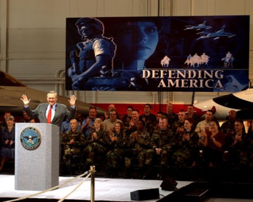 Secretary of Defense Donald H. Rumsfeld acknowledges the applause of the audience at Nellis Air Force Base, Nev., as he begins a town hall meeting on Feb. 20, 2002. Rumsfeld is visiting Nellis to meet the troops and the local commanders stationed there. 
