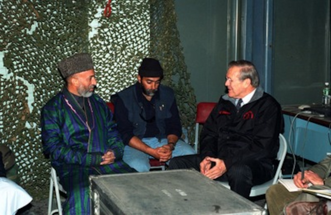 Hamid Karzai (left) meets with Secretary of Defense Donald H. Rumsfeld (right) at Bagram Air Base, Afghanistan, on Dec. 16, 2001. Karzai, the newly appointed interim prime minister of Afghanistan, is meeting with Rumsfeld to discuss the military action against the forces of the al Qaeda terrorist organization and the ruling Taliban regime in Afghanistan. 
