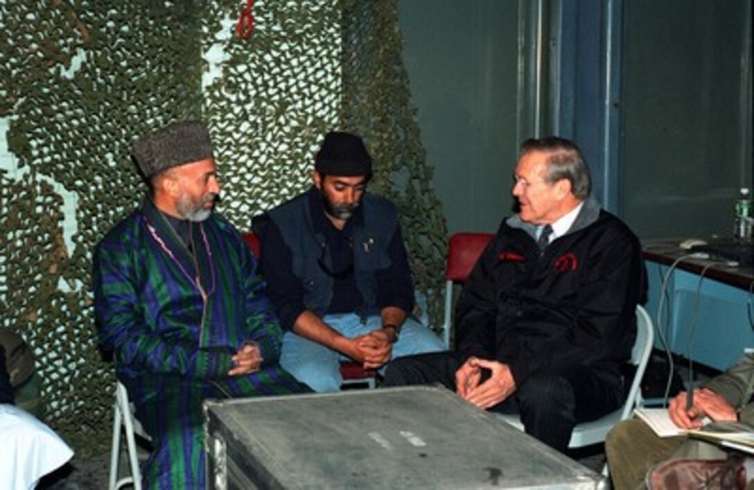Hamid Karzai (left) meets with Secretary of Defense Donald H. Rumsfeld (right) at Bagram Air Base, Afghanistan, on Dec. 16, 2001. Karzai, the newly appointed interim prime minister of Afghanistan, is meeting with Rumsfeld to discuss the military action against the forces of the al Qaeda terrorist organization and the ruling Taliban regime in Afghanistan. 