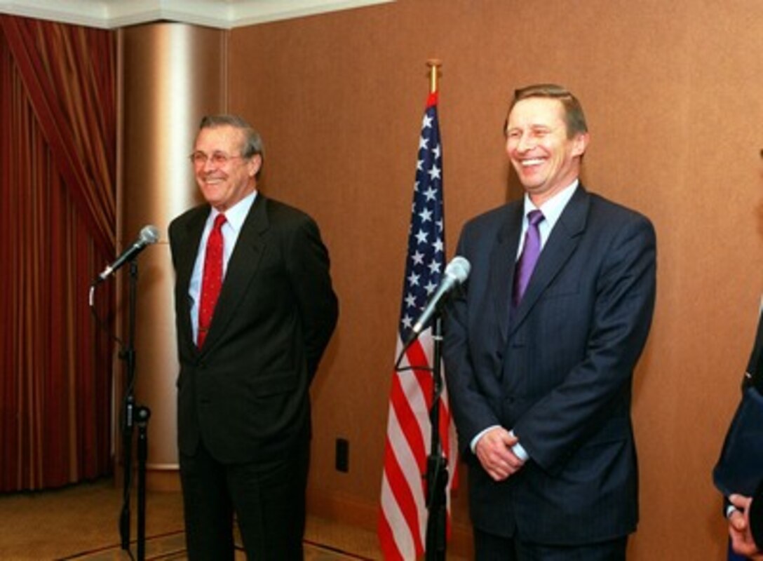Secretary of Defense Donald H. Rumsfeld (left) and Russian Minister of Defense Sergey Ivanov share a light moment during a joint press availability on Dec. 17, 2001, in Brussels, Belgium. The two defense leaders are in Brussels for the NATO Defense Ministerial meetings. 