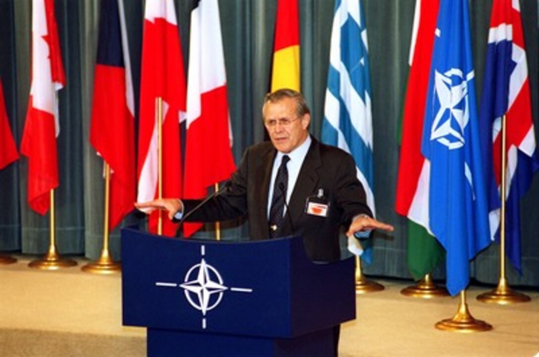 Secretary of Defense Donald H. Rumsfeld conducts a press briefing at NATO Headquarters in Brussels, Belgium, on Dec. 18, 2001. Rumsfeld is attending the semi-annual NATO Defense Ministerial Meetings. 