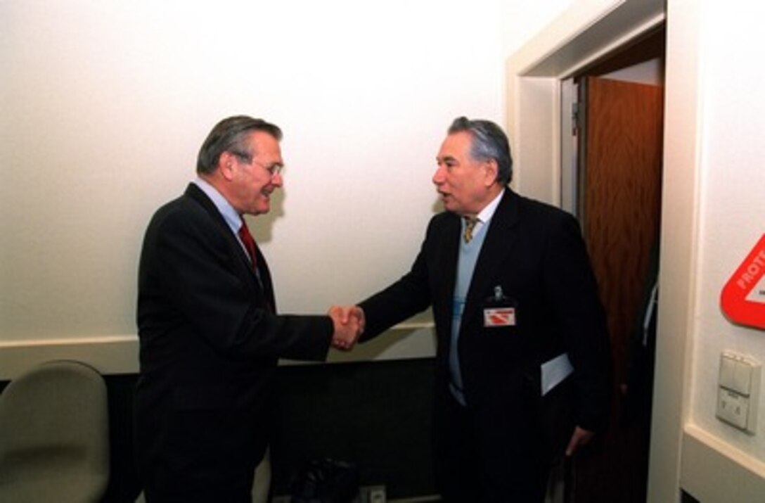 Secretary of Defense Donald H. Rumsfeld (left) greets Kyrgystan Ministry of Defense First Deputy Gen. Maj. T. Asylbek Ormokoyev prior to their bilateral meeting at NATO Headquarters in Brussels, Belgium, on Dec. 19, 2001. The two defense leaders are in Brussels for the NATO Defense Ministerial meetings. 