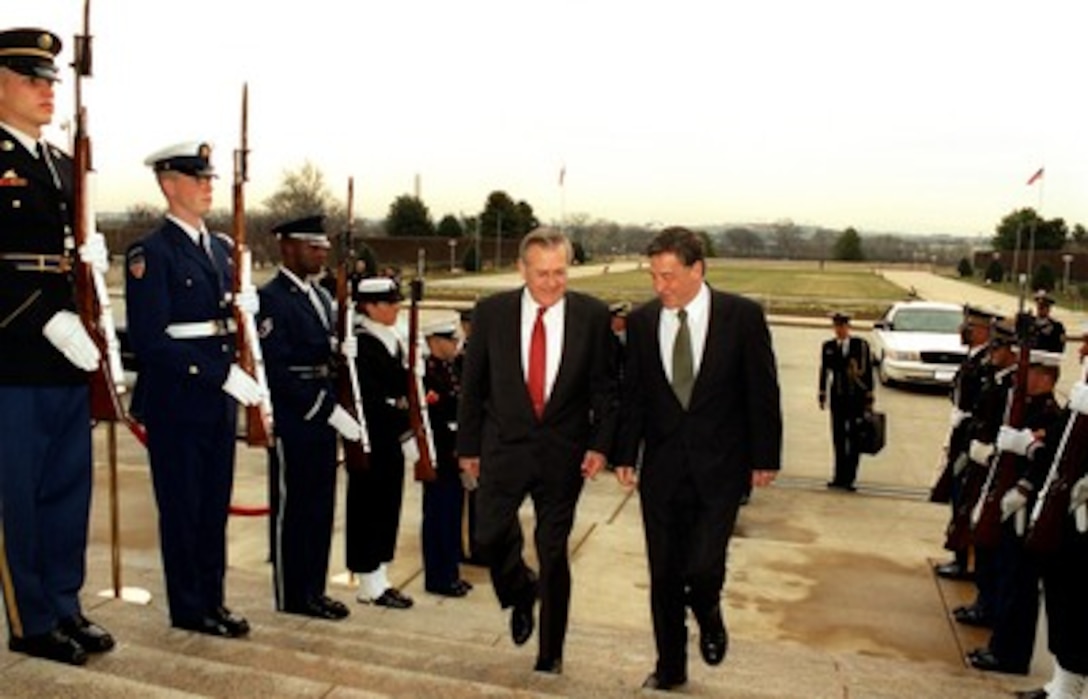 Secretary of Defense Donald H. Rumsfeld escorts Australian Minister of Defense Robert M. Hill through an honor cordon and into the Pentagon on Jan. 10, 2002. The two leaders are meeting to discuss defense issues of mutual interest. 