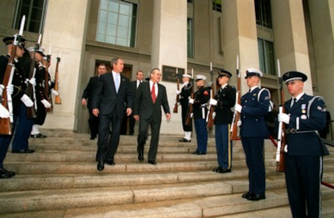 Secretary of Defense Donald H. Rumsfeld escorts President George W. Bush from the Pentagon on Jan. 10, 2002. Bush addressed military and Department of Defense personnel at the Pentagon and signed the Defense Appropriations Bill. 