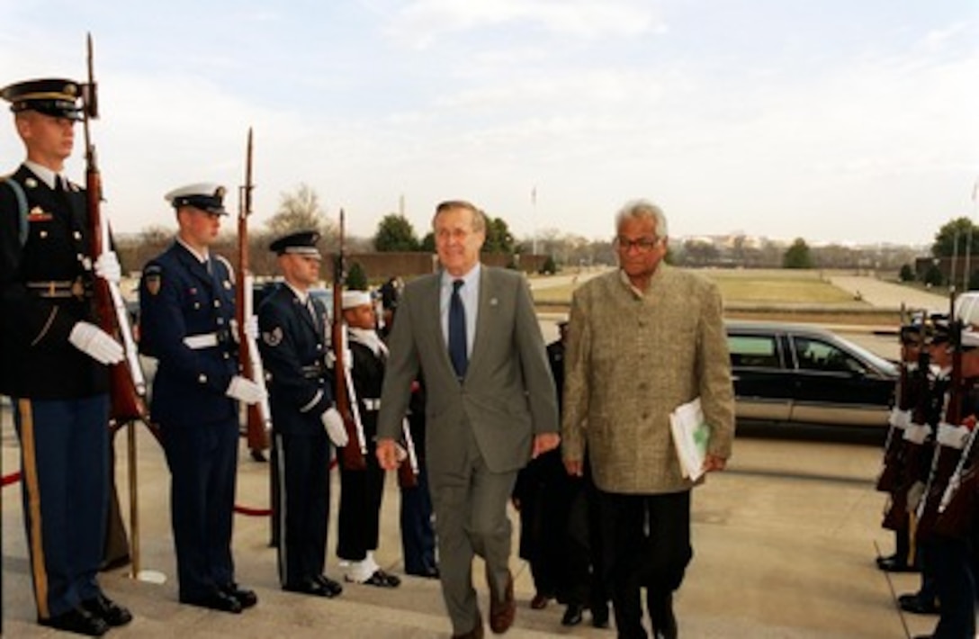 Secretary of Defense Donald H. Rumsfeld escorts Indian Minister of Defense George Fernandes into the Pentagon on Jan. 17, 2002. Rumsfeld and Fernandes will meet to discuss defense issues of mutual interest. 