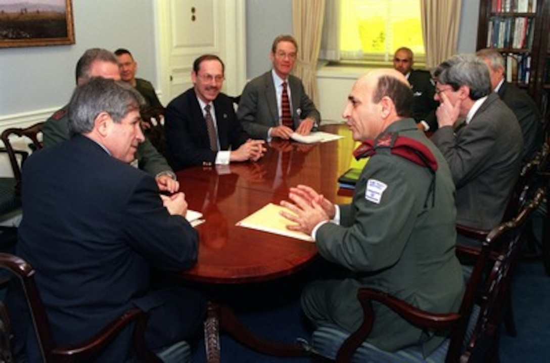 Israeli Chief of Defense Lt. Gen. Shaul Mofaz (right foreground) meets with Deputy Secretary of Defense Paul Wolfowitz (left), and other senior DoD officials in the Pentagon on Jan. 18, 2002. Under discussion is a range of bilateral security issues. 