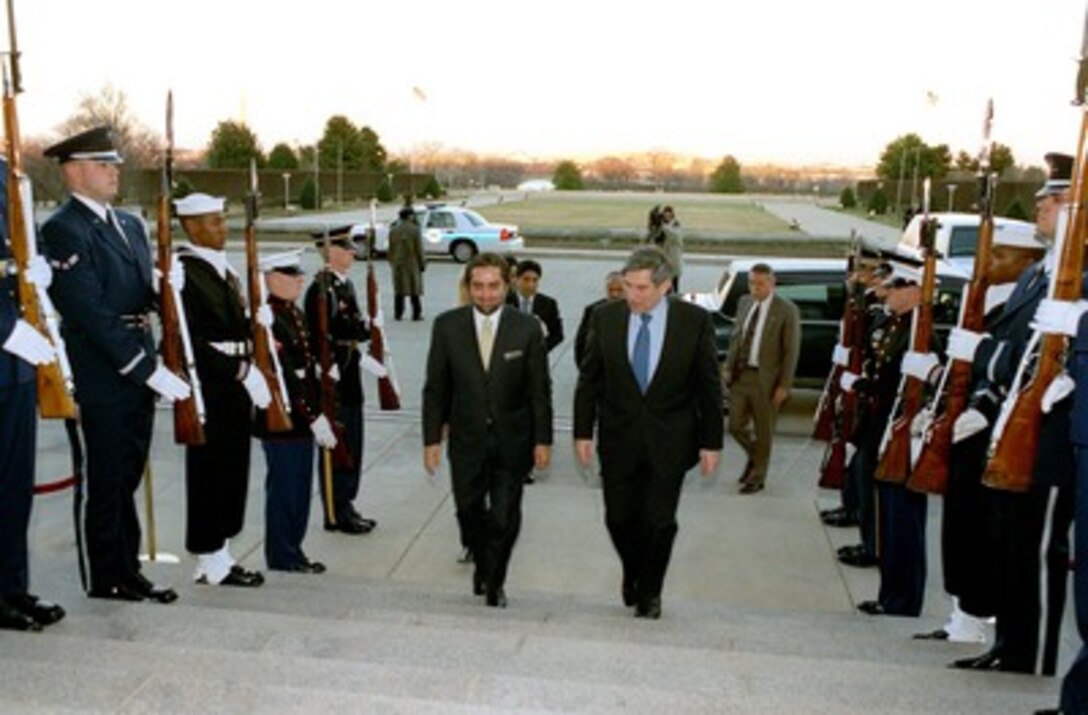 Afghan Interim Authority Foreign Minister Abdullah Abdullah (left) is escorted through an honor cordon and into the Pentagon by Deputy Secretary of Defense Paul D. Wolfowitz on Jan. 25, 2002. Abdullah and Wolfowitz will meet to discuss the war on terrorism in Afghanistan. 