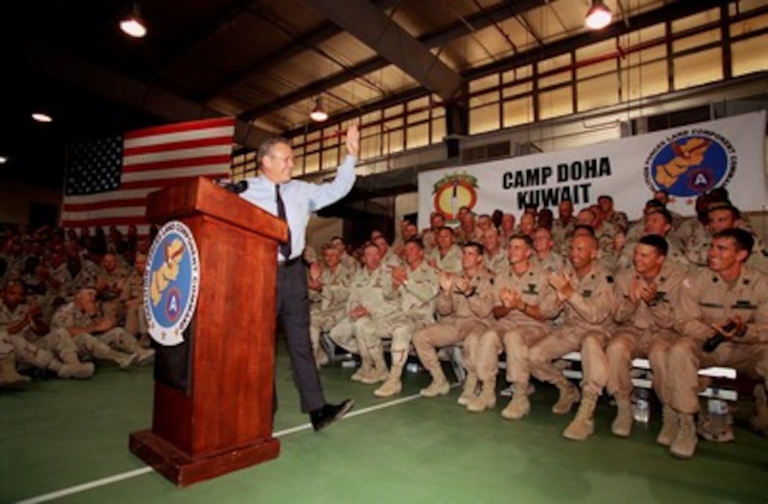 Secretary of Defense Donald H. Rumsfeld responds to the troops' applause during a Town Hall meeting at Camp Doha, Kuwait, on June 9, 2002. Rumsfeld is on a 10-day tour of nine countries to meet with senior leaders and to visit with U.S. troops deployed abroad. 