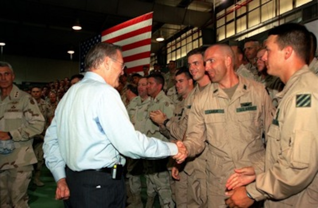 Secretary of Defense Donald H. Rumsfeld shakes hands with some of the troops deployed to Camp Doha, Kuwait, on June 9, 2002. Rumsfeld is on a 10-day tour of nine countries to meet with senior leaders and to visit with U.S. troops deployed abroad. 