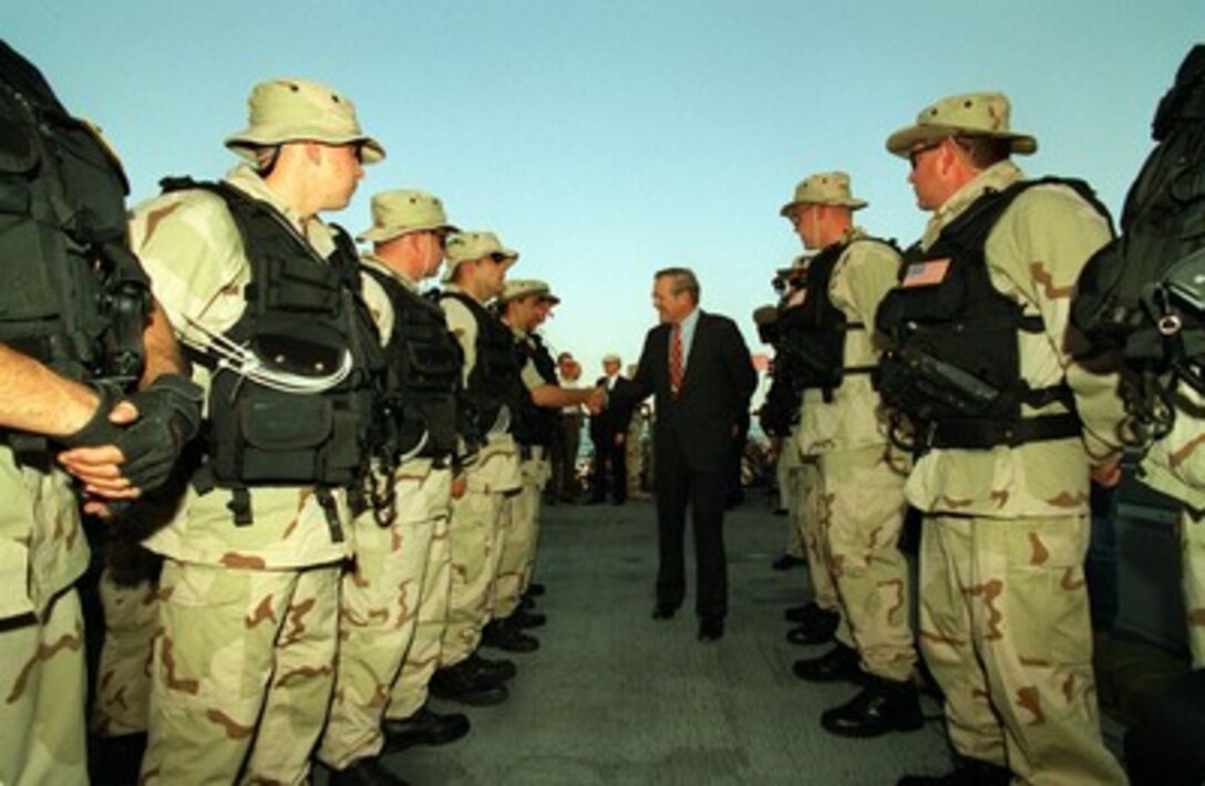 Secretary of Defense Donald H. Rumsfeld shakes hands with crew members of the destroyer USS Carney (DDG 64) while in port in Bahrain on June 10, 2002. Rumsfeld is on a 10-day tour of nine countries to meet with senior leaders and to visit with U.S. troops deployed abroad. 