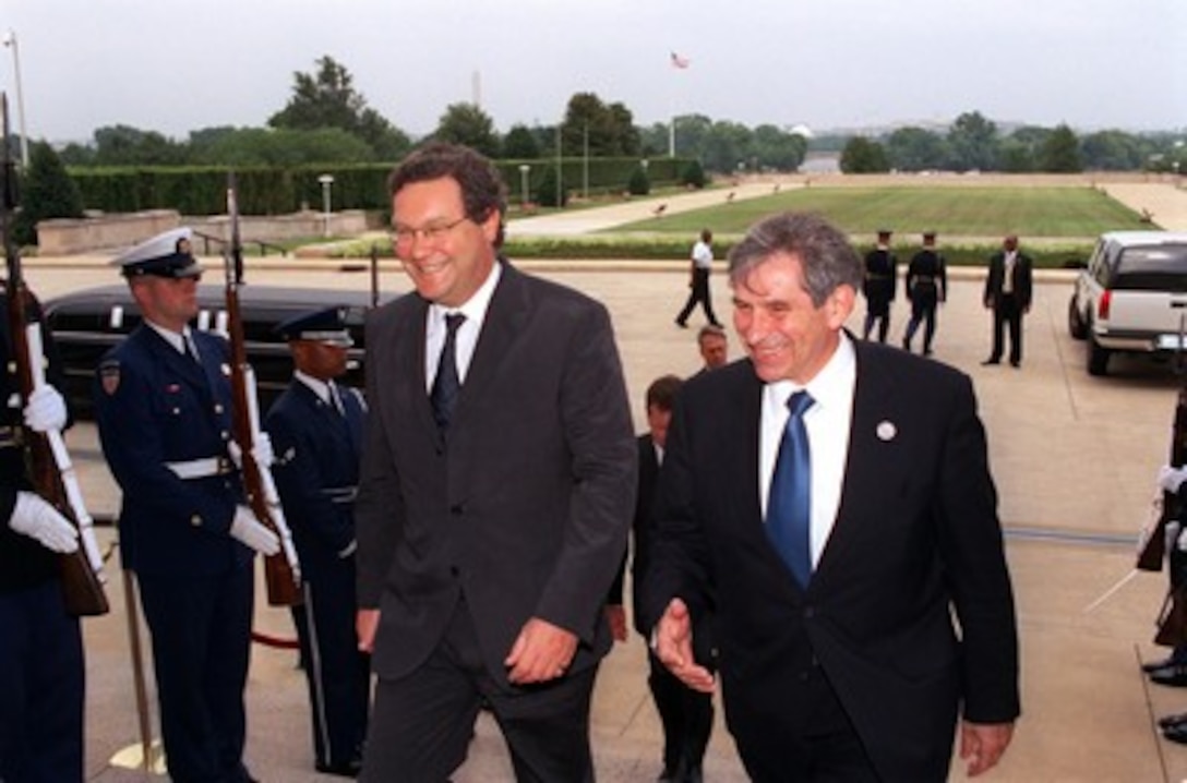 Deputy Secretary of Defense Paul Wolfowitz (right) escorts Australian Minister of Foreign Affairs Alexander Downer (left) through an honor cordon and into the Pentagon on July 10, 2002. The two men will meet to discuss a range of security issues of mutual interest to both nations. 