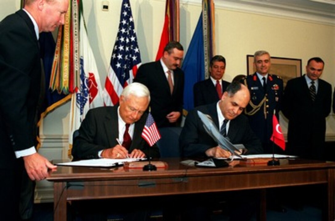 Under Secretary of Defense for Acquisition, Technology, and Logistics Edward C. "Pete" Aldridge (seated left) and Turkish Under Secretary for Defense Industries Ali Ercan (seated right) sign a memorandum of understanding in the Pentagon on July 11, 2002. The memorandum commits Turkey to participate in the Joint Strike Fighter system development and demonstration phase. The Joint Strike Fighter is the military's next generation, multi-role, strike aircraft designed to complement the Navy F/A-18 and the Air Force F-22 aircraft. Turkey joins the U.S., United Kingdom, Italy, Netherlands, Canada, Denmark, and Norway in the development of this highly capable and versatile strike aircraft. 