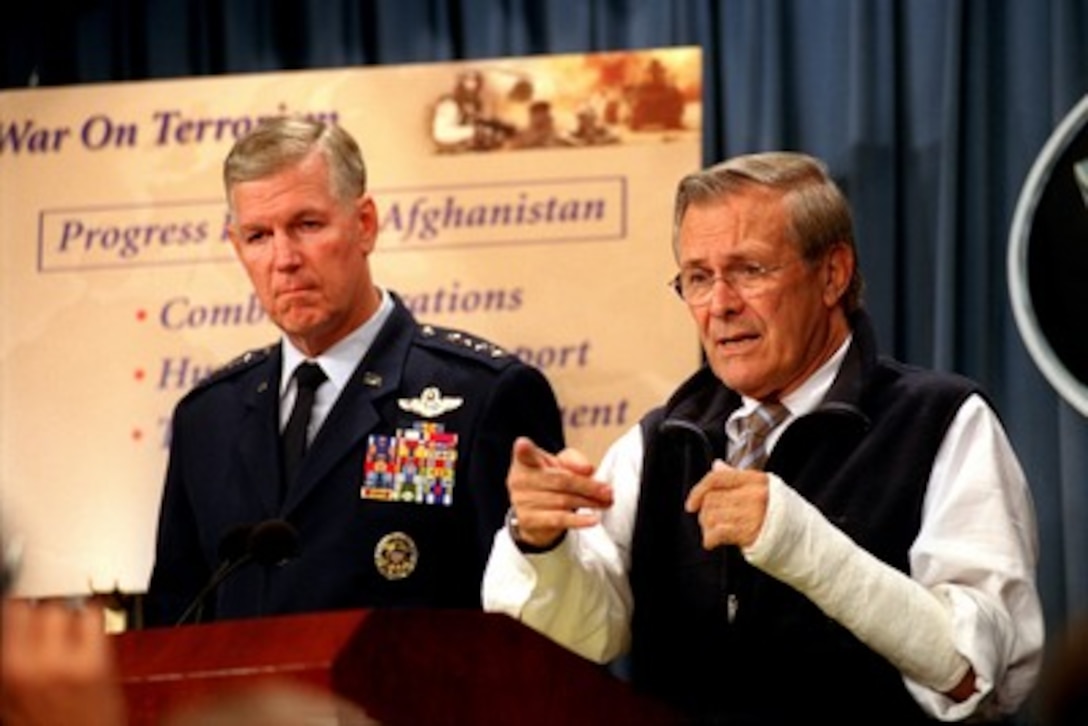 Secretary of Defense Donald H. Rumsfeld (right) and Chairman of the Joint Chiefs of Staff Gen. Richard B. Myers, U.S. Air Force, hold a Pentagon press conference on July 22, 2002. Rumsfeld and Myers reviewed the accomplishments of the coalition in the war against terrorism during the past nine months in Afghanistan. Rumsfeld's left forearm is in a cast following recent surgery to repair an arthritic thumb. 