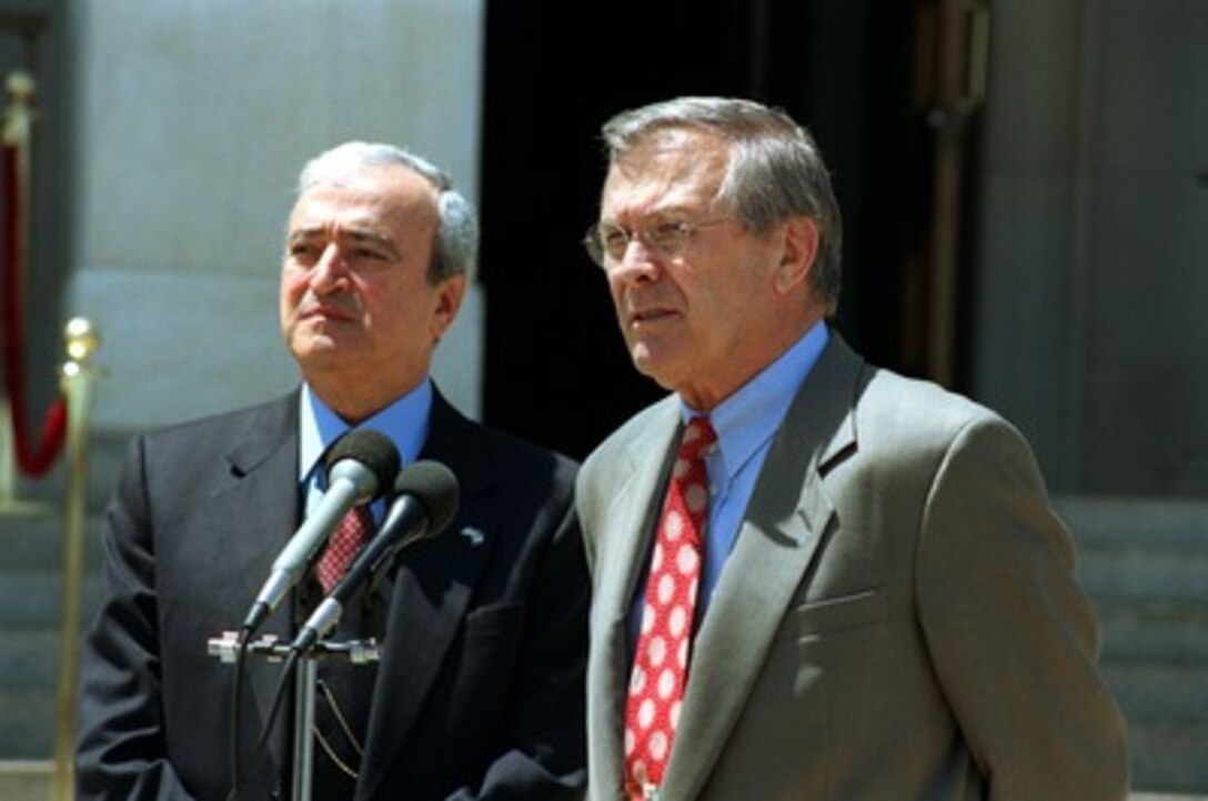 Secretary of Defense Donald H. Rumsfeld (right) responds to reporter's question during a joint press conference with Italian Minister of Defense Antonio Martino at the Pentagon on May 10, 2002. Rumsfeld and Martino met earlier to discuss defense issues of mutual interest. 
