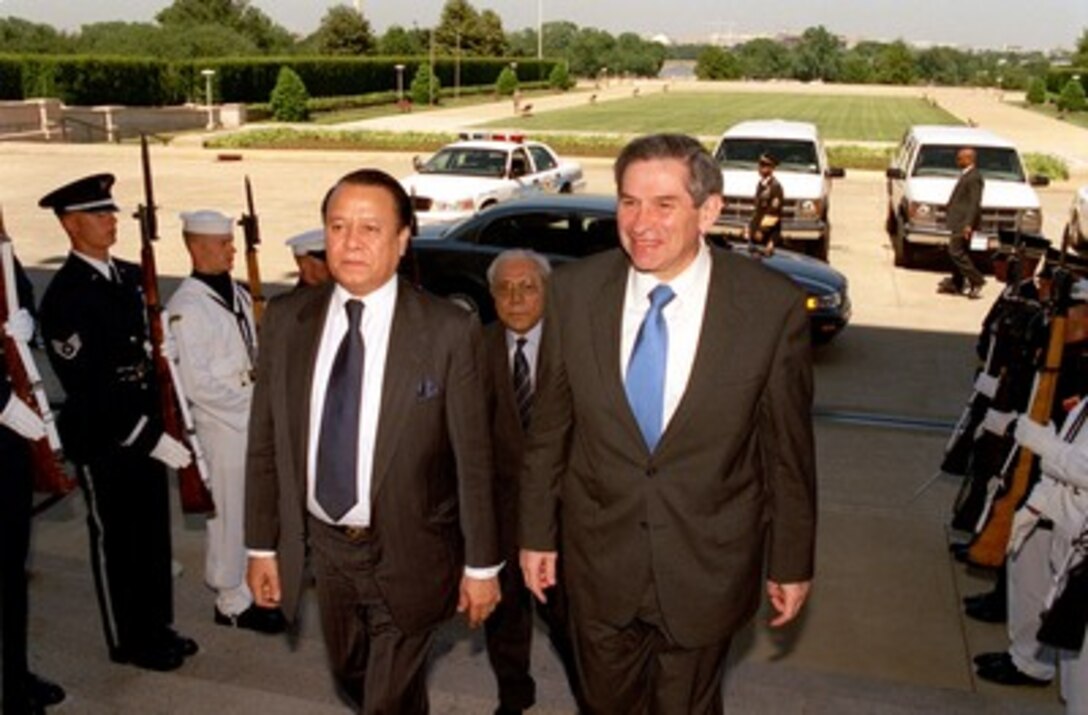 Deputy Secretary of Defense Paul Wolfowitz (right) escorts Minister of Foreign Affairs Morshed Khan (left), of Bangladesh, into the Pentagon on May 23, 2002. The two men will meet to discuss a range of bilateral security issues. Bangladesh's Ambassador to the United States Ahmad Tariq Karim (center) will join Wolfowitz and Khan in the talks. 