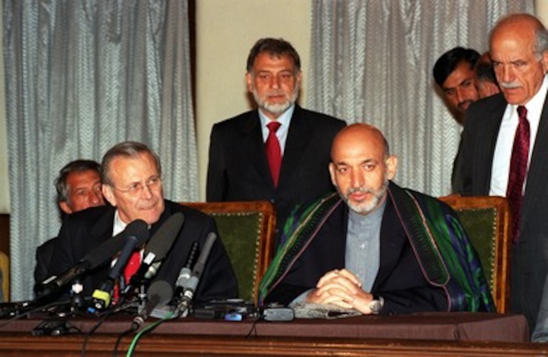 Secretary of Defense Donald H. Rumsfeld (left) and Afghan Interim Authority Chairman Hamid Karzai (right) speak to reporters at the Presidential Palace in Kabul, Afghanistan, on April 27, 2002. Rumsfeld is in Afghanistan as part of a five-day trip to various nations of Central Asia. 